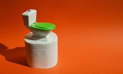 a small toilet and toilet paper. hygiene supplies. background for the design