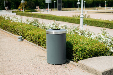 Public metal gray trash can in Park on city street outdoors. Help to reduce waste, Help global...