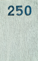 Striped gray wall with the number 250 at the top. Space for advertising. Vertical.