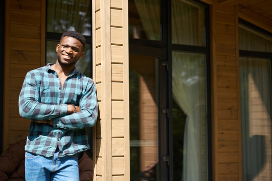 Nice guy stands on a sunny terrace