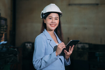 Portrait of  Engineer inspecting and check up machine at factory machines. Industrial worker working and checking Material or Machine at industry manufactory.