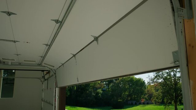 Garage Door Opening Move Down. Inside in garage wide shot footage
