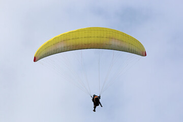 Tandem Paraglider flying in a blue sky	