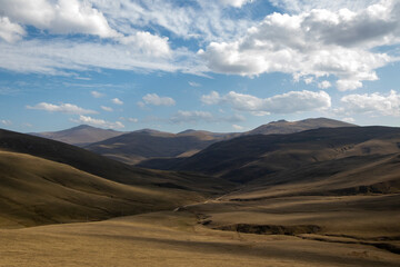 Fototapeta premium Landscape of grassland with blue sky and white clouds in the background