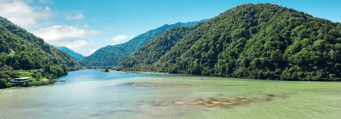 Panorama of mountains, sky and mountain river in summer, landscape