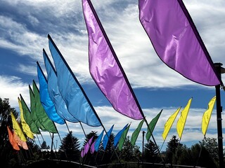 Colorful flags over a footbridge in summer 20210625..