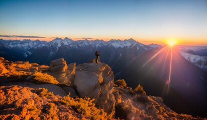 Hiker on the top of the mountain with a backpack and enjoying the view of the sunrise