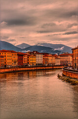 Pisa Lungarno under a dramatic sky, Italy.