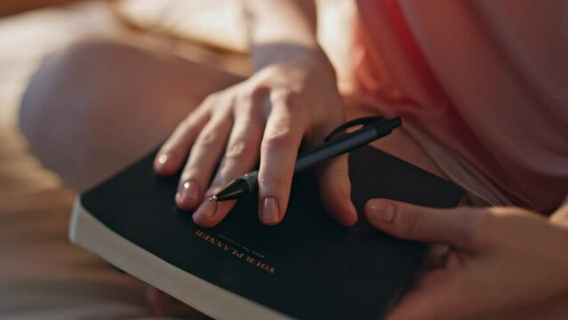 Hand making handwriting notes closeup. Girl holding pen planning day in morning.