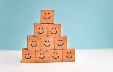 Survey concept with smiling faces on wooden blocks