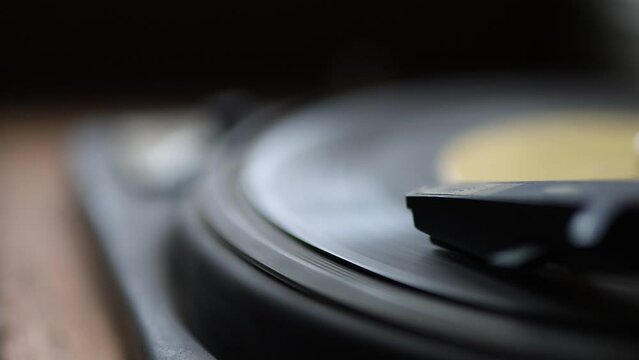 the record is spinning on an old gramophone player