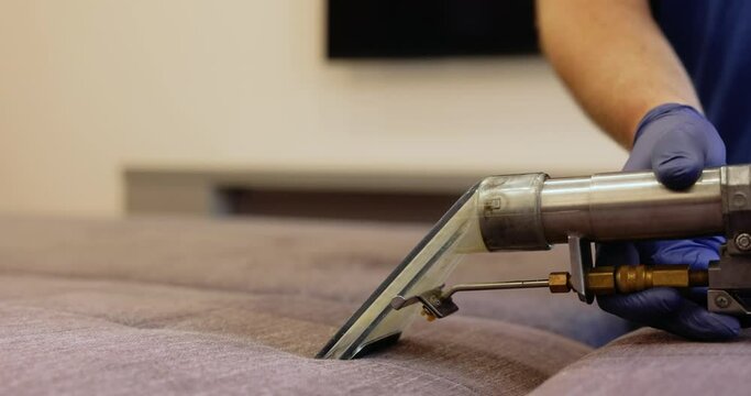 Dry cleaning of furniture upholstery with washing vacuum cleaner.