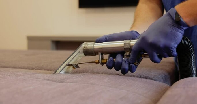 Dry cleaning of furniture upholstery with washing vacuum cleaner.