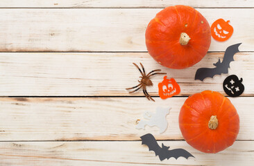 Halloween decoration and pumpkins on wooden background, top view