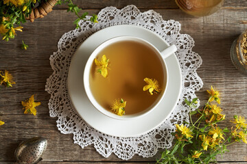 Fresh St. John's wort flowers in a white cup of herbal tea