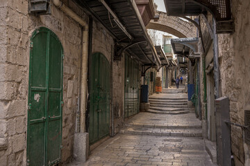 Fototapeta na wymiar The empty streets and the stone stairs of the historic old city of Jerusalem in Israel.