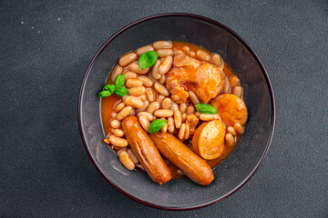 cassoulet thick bean soup with meat, beans, sausages delicious healthy eating cooking appetizer meal food snack on the table copy space food background rustic top view