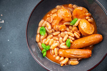cassoulet thick bean soup with meat, beans, sausages delicious healthy eating cooking appetizer meal food snack on the table copy space food background rustic top view