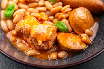 cassoulet thick bean soup with meat, beans, sausages delicious healthy eating cooking appetizer meal food snack on the table copy space food background rustic top view