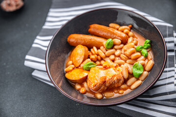 cassoulet thick bean soup with meat, beans, sausages delicious healthy eating cooking appetizer meal food snack on the table copy space food background rustic top view