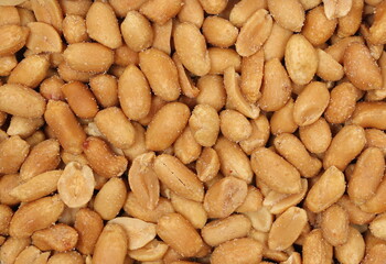 Roasted and salted peanuts pile background and texture, top view