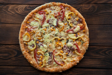 homemade large pizza on a wooden table