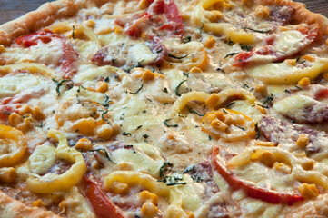 homemade large pizza on a wooden table