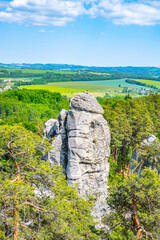 Panoramic view of a sandstone rock city in Bohemian Paradise, Czech: Cesky raj. Rock climbers on top of a rocky tower. Czech Republic - obrazy, fototapety, plakaty