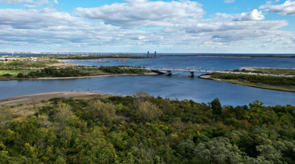 aerial view of BQE (brooklyn queens expressway) with gil hodges bridge in the background from marine park in brooklyn new york city (nyc) bridges, traffic, cars, water, bay, beach, marsh, jamaica bay
