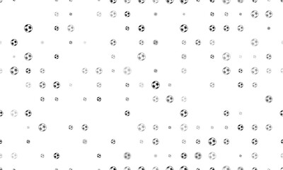 Seamless background pattern of evenly spaced black football symbols of different sizes and opacity. Illustration on transparent background