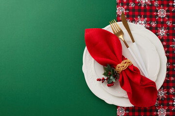 Crafting a magical Christmas table setting..Top view of plates, cutlery, fir twig, napkin,...
