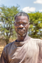 portrait of an handsome middle age african man with masculine features, standing outdoors