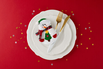 Designing Christmas: your table preparation starts now. Top view shot of snowman on the plate,...