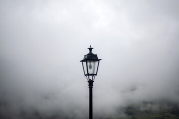 A streetlight in the middle of the fog