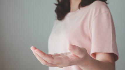 Naklejka premium Open hand concept. Young woman outstretched in gesture of help empty hand. for give, offer, hold, receive, showing, present, display, or product on a person palm on white background. Business theme.