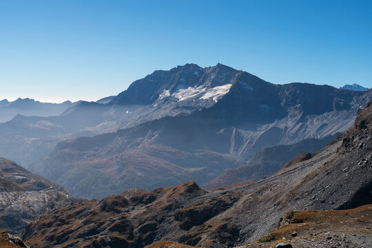 landscape of Levanne mountains in Gran Paradiso National Park, blue sky and Orco Valley with haze
