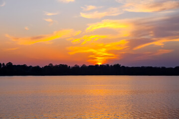 Peaceful landscape with lake in autumn sunset light in Latvia.