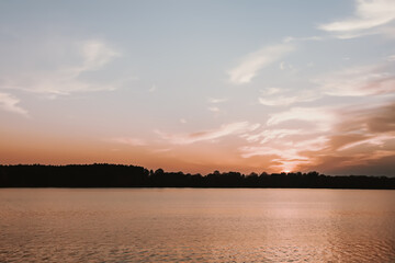 Peaceful landscape with lake in autumn sunset light in Latvia.