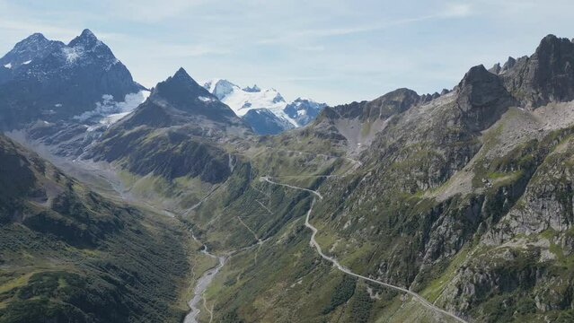 A drone view of the high mountains with the switchback roads on it.