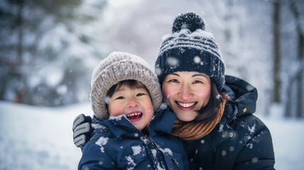 Fototapeta premium Happy parent and child in winter looking at camera.