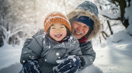 Fototapeta na wymiar Winter portrait of happy parent and child having fun together in snowy forest.
