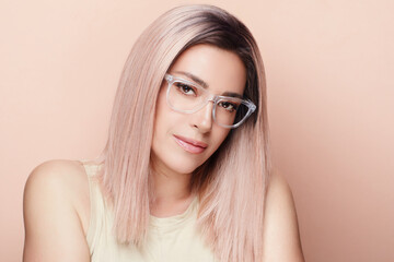 Young adult woman with long hair and glasses, front view portrait photography. With copy space.