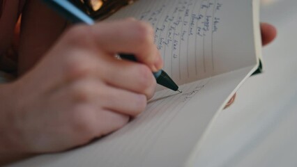 Hands making diary notes closeup. Happy smiling girl holding pen writing plans