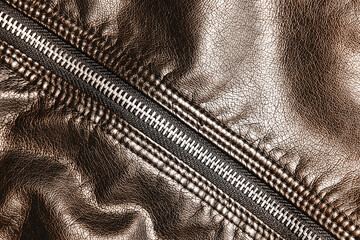 Brown leather jacket background. Autumn color clothing. Autumn winter fashion texture. Closed fastener. Zipped zipper. Fabric design pattern. Metal zipper background. 