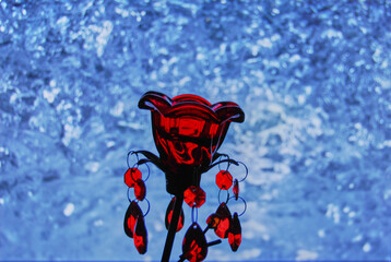 Red decorative flower on a background of water.