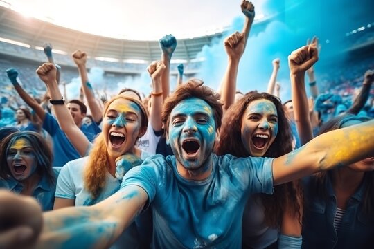 Sport Stadium Soccer Match: Diverse Crowd of Fans Cheer for their blue Team to Win. People Celebrate Scoring a Goal, Championship Victory. Group People with Painted Faces Cheer, Shout, Have Fun