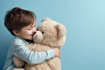 a child hugging a teddy bear - obrazy, fototapety, plakaty