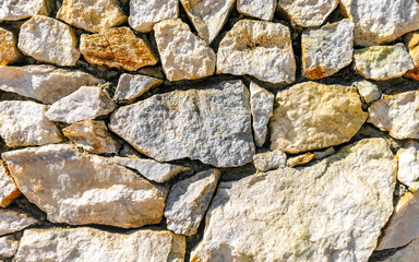 Texture detail of wall with rocks stones brick bricks Mexico.