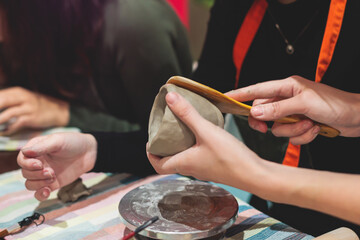 Pottery lesson master class for kids children, process of making clay pot on pottery wheel, potter...