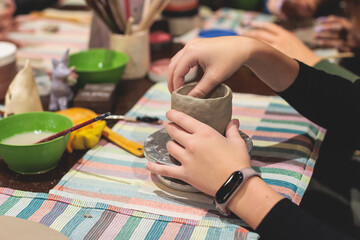 Pottery lesson master class for kids children, process of making clay pot on pottery wheel, potter hands creating ceramic crockery handcrafts, ceramist molding and painting jar or vase